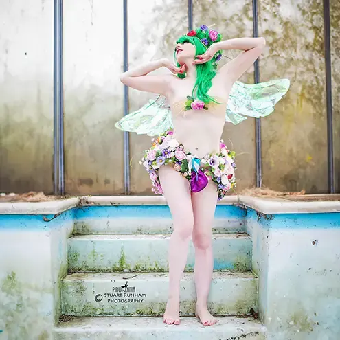 a burlesque fairy with green hair