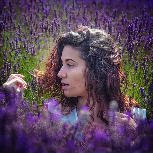 A model posing amongst some lavender