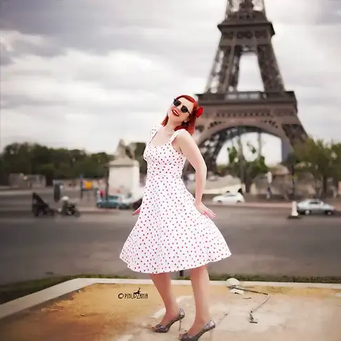 A fashion model posing in front of the Eifel Tower, Paris