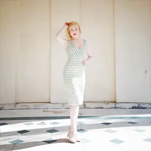 singer modelling photos, a blonde in a silver dress in a brightly lit gazebo, fashion photography